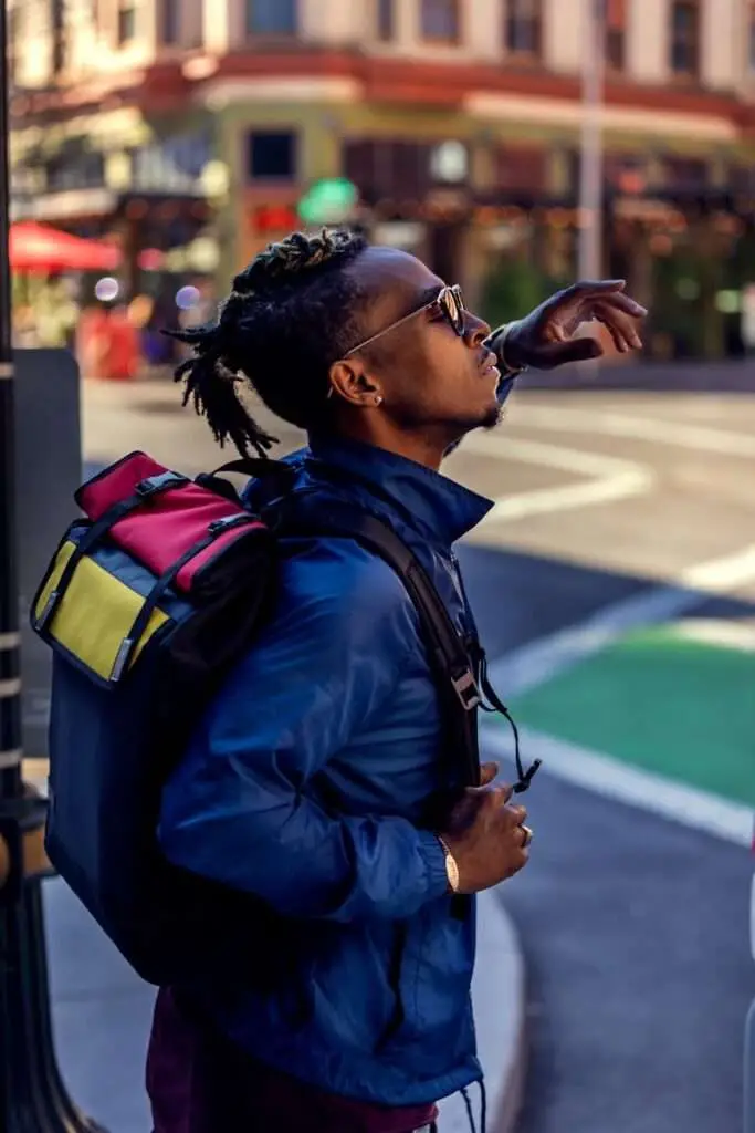 Selective Focus Photo of Man Carrying Backpack